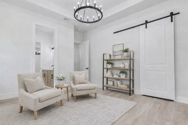 a living room with furniture a rug and white walls