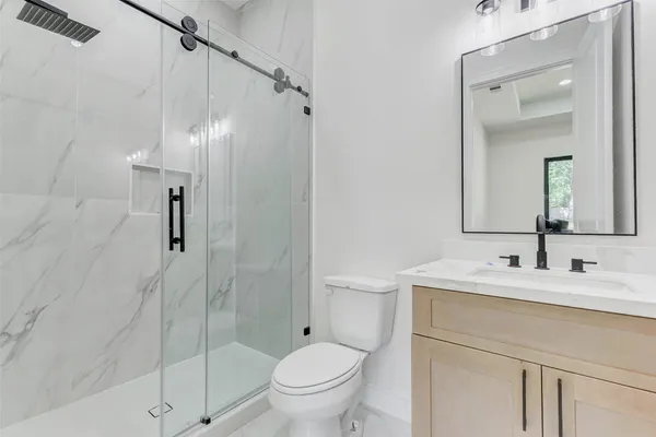 a bathroom with a sink toilet and shower