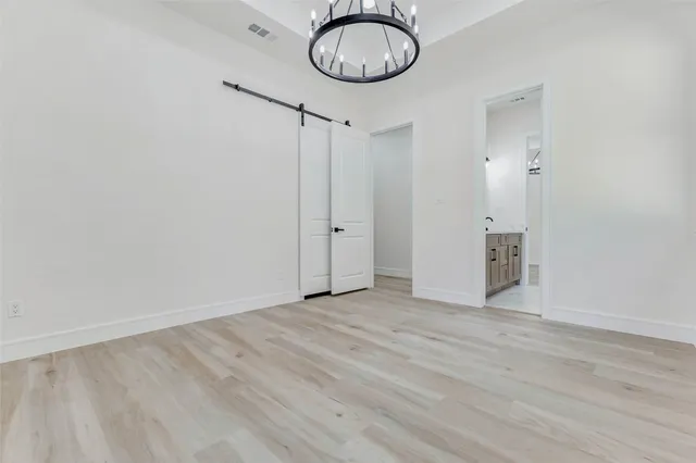 a view of a room with wooden floor and white wall