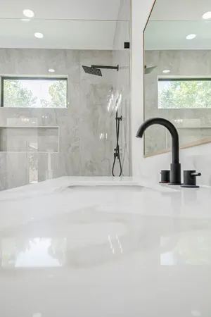 a close view of a faucet a sink a faucet and a shower