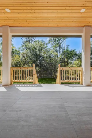a view of a big room with wooden floor and outdoor space