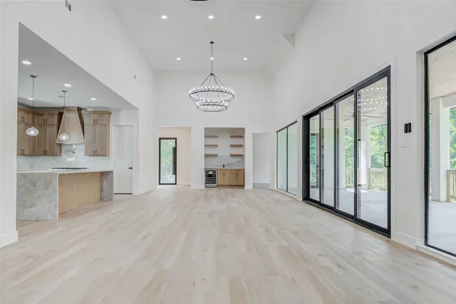 a view of an empty room with a window and cabinet