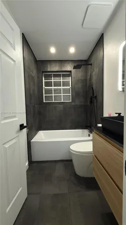 a bathroom with a bathtub sink and toilet