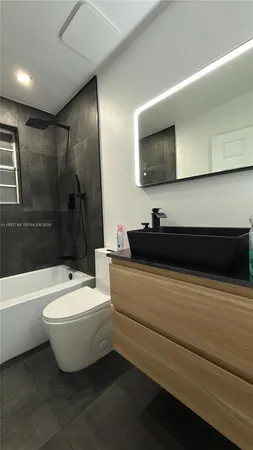a bathroom with a toilet a sink and bathtub