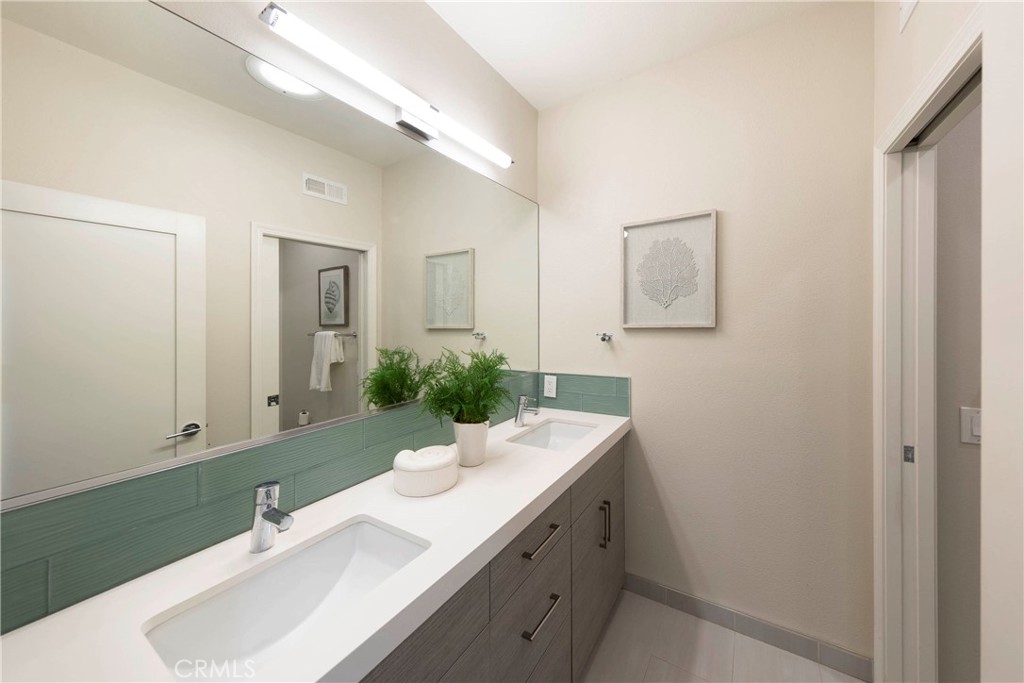 43 Lessay Newport Coast, CA 92657 - Photo 25 of 29 Double sink secondary bathroom with private toilet and tub.