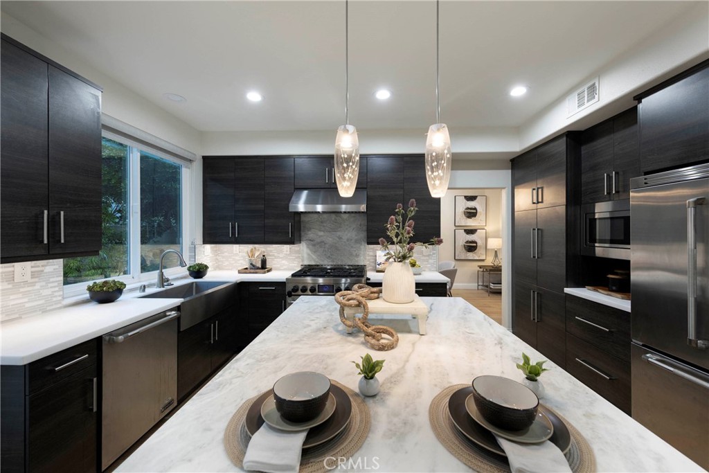 43 Lessay Newport Coast, CA 92657 - Photo 9 of 29 Remodeled kitchen boasting quality appliances and finishes.