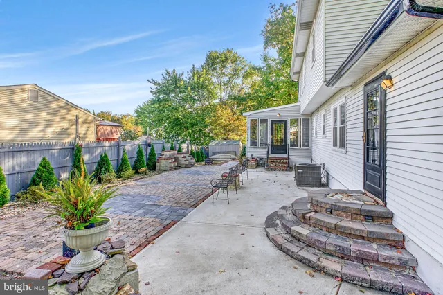 a view of a patio with table and chairs and potted plants