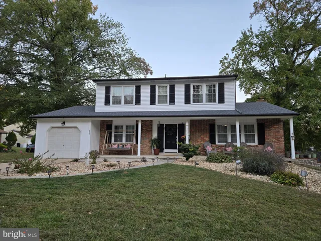 a front view of a house with garden and porch