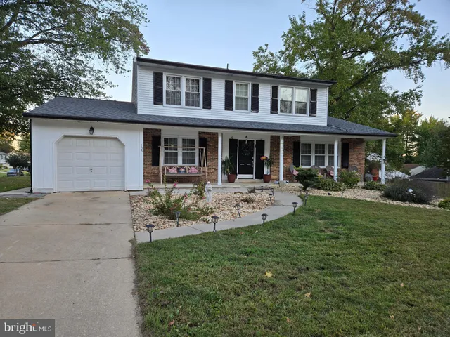 a front view of a house with garden and porch
