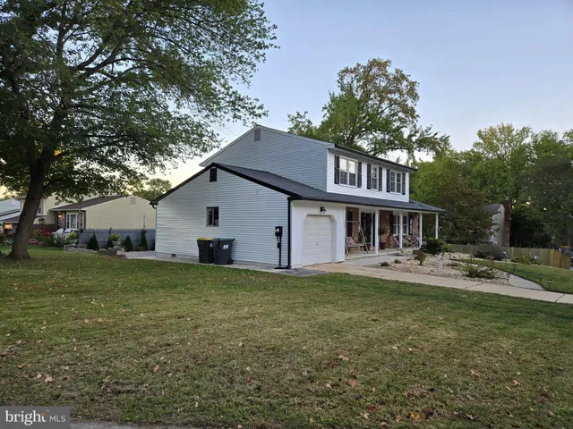 a view of a house with a yard and sitting area