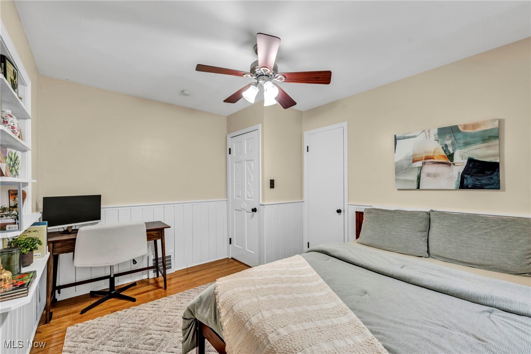 1317 Belrose Road Cleveland, OH 44124 - Photo 17 of 50 Bedroom with an office area, wainscoting, wood finished floors, and ceiling fan