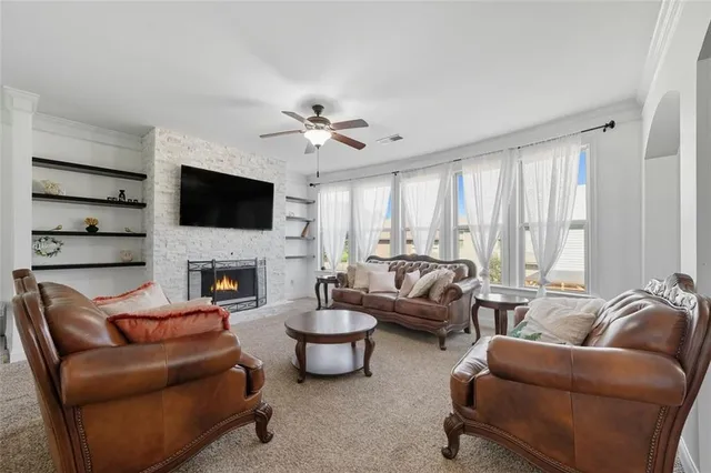a living room with furniture a fireplace and a flat screen tv