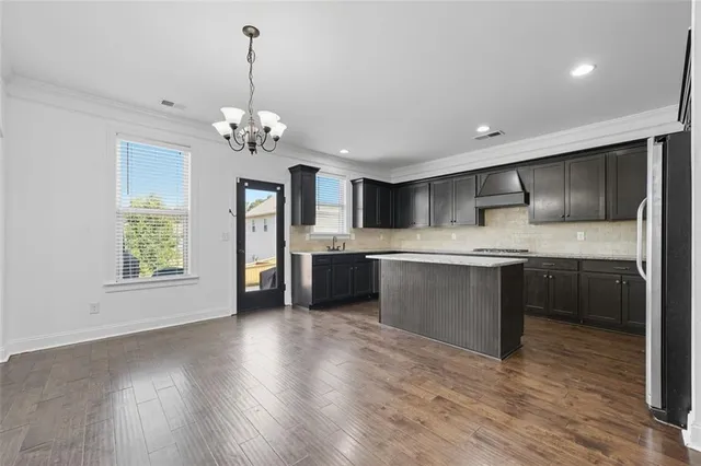 a kitchen with a refrigerator sink and cabinets