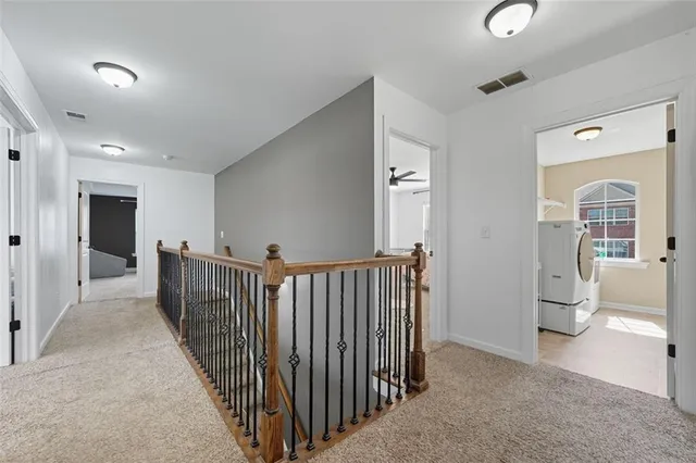 a view of a hallway with a sink and a refrigerator