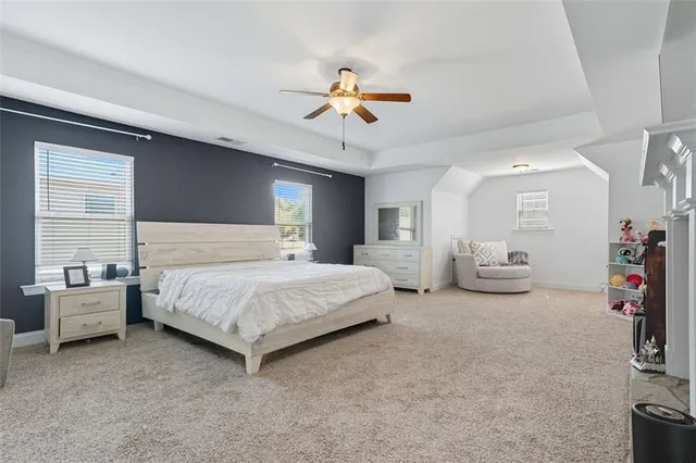 a bedroom with bed and a chandelier