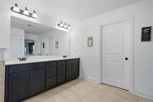 a spacious bathroom with a double vanity sink and a mirror