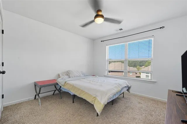 a bedroom with a bed and a window