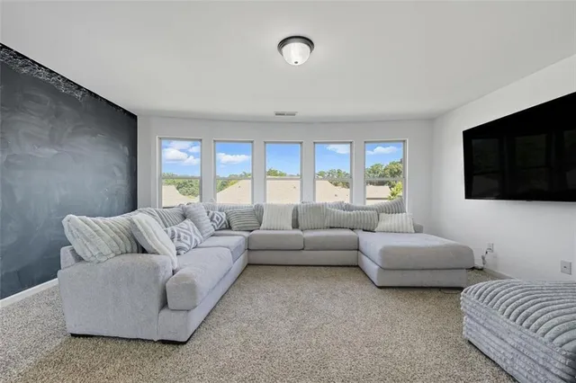 a living room with couches and a flat screen tv