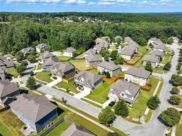 an aerial view of a house with a yard