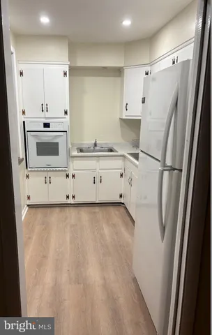 a kitchen with stainless steel appliances a refrigerator sink and cabinets