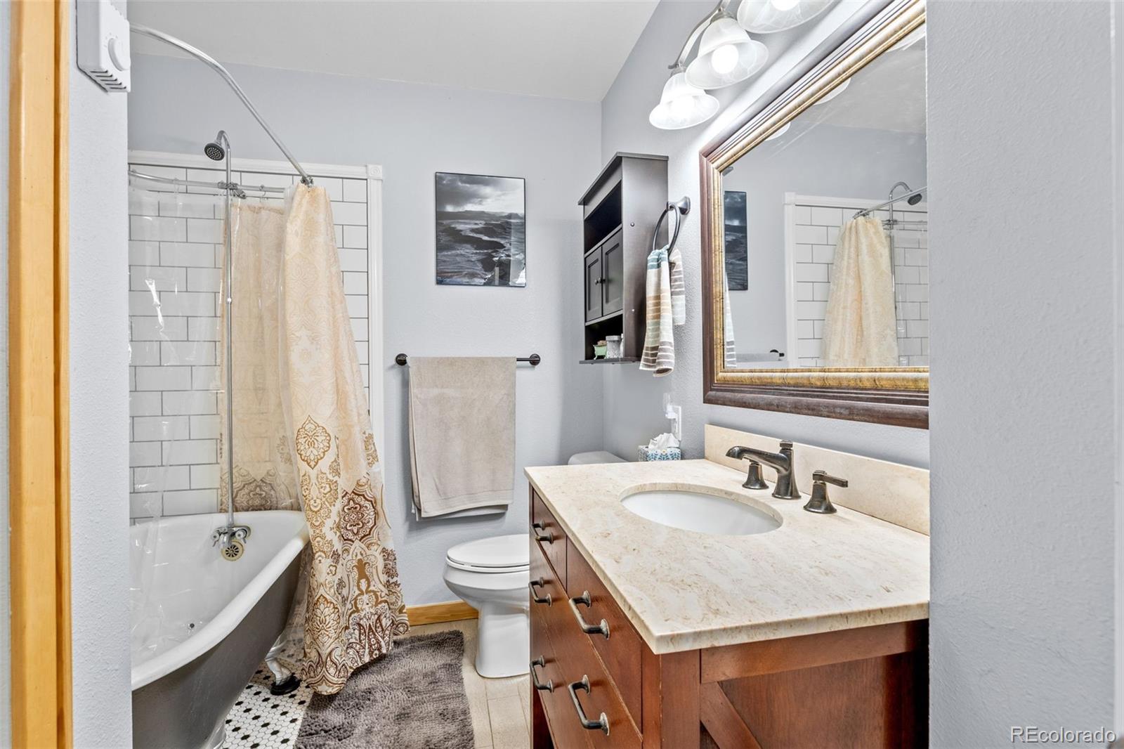 987 Wisp Creek Drive Bailey, CO 80421 - Photo 15 of 22 a bathroom with a tub sink and mirror