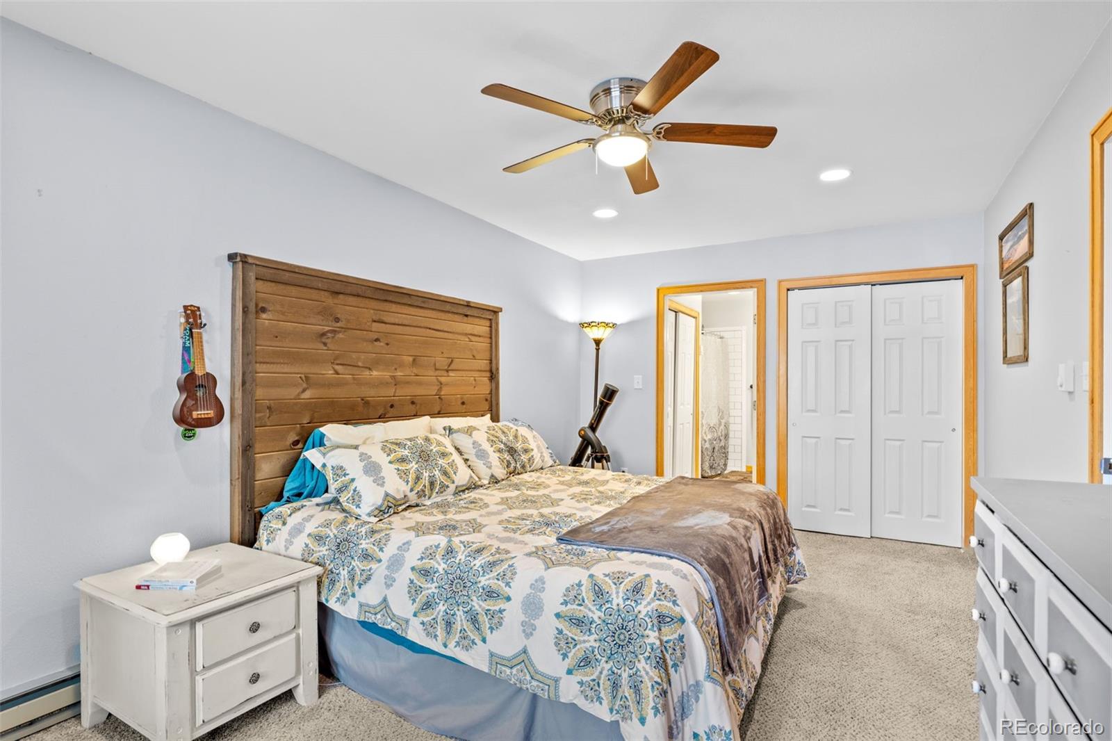 987 Wisp Creek Drive Bailey, CO 80421 - Photo 5 of 22 a bedroom with a bed and a chandelier
