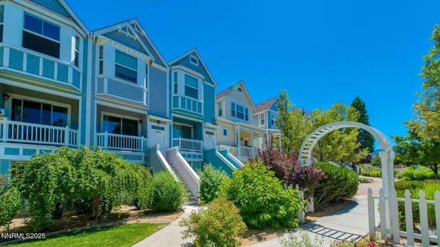 a front view of a house with plants and entryway