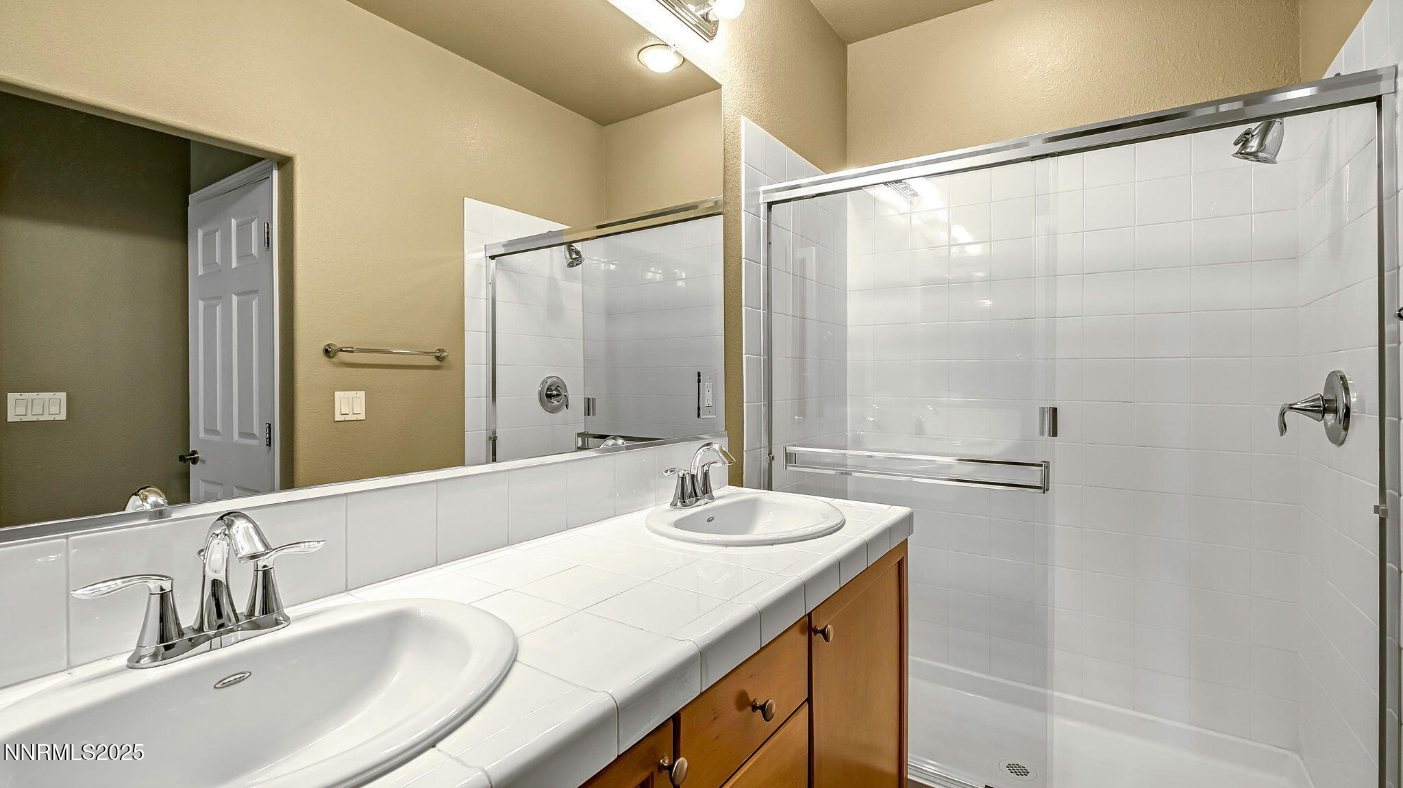 225 Gramercy Lane Reno, NV 89509 - Photo 22 of 40 a bathroom with a double vanity sink and mirror