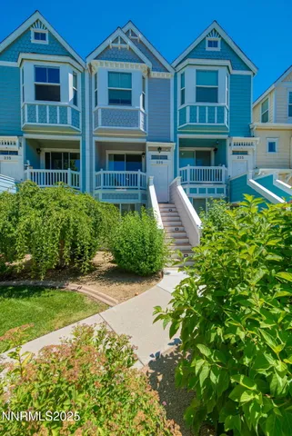 a front view of a residential apartment building with a yard