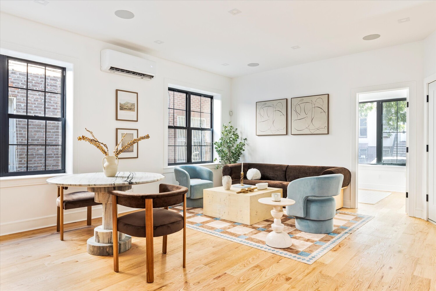 a living room with furniture a table and chair