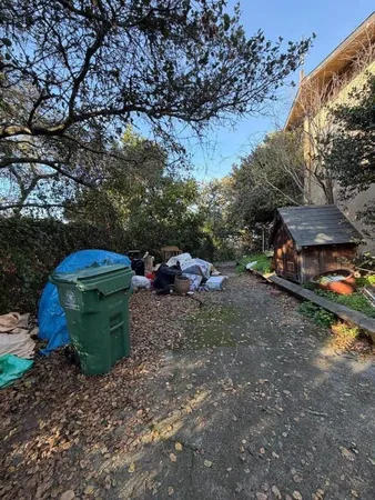 a backyard of a house with a yard and outdoor seating