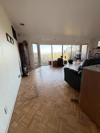 a living room with furniture gym equipment and a large window