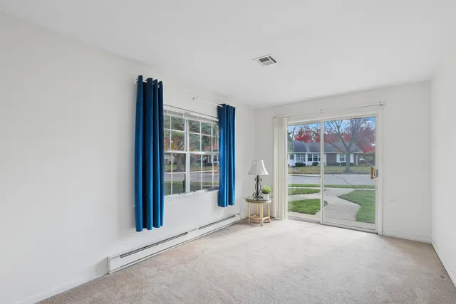 a view of a yard with a tree in the background