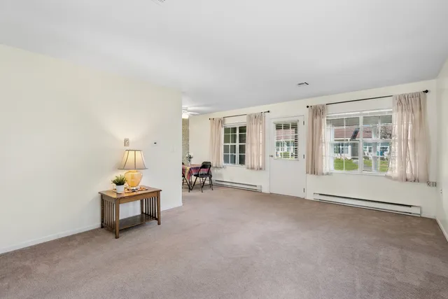 an empty room with furniture and windows