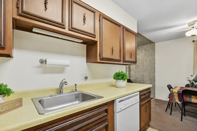 a kitchen with a sink cabinets and window