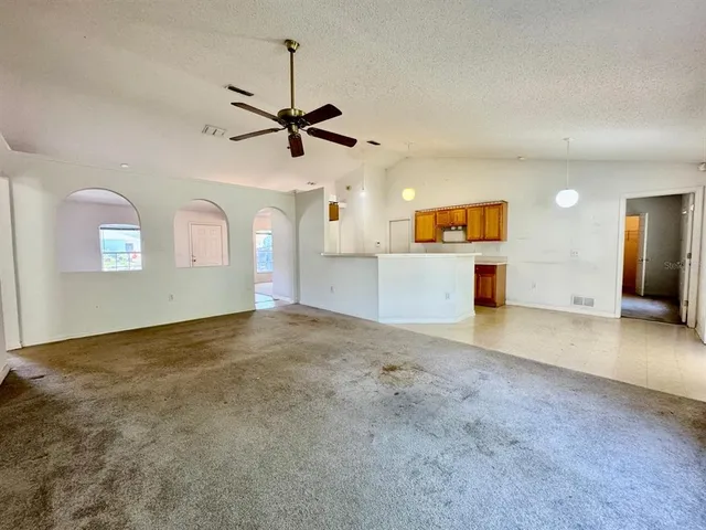 a kitchen with a sink cabinets and wooden floor