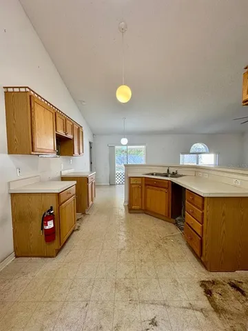 a kitchen with a refrigerator and a stove