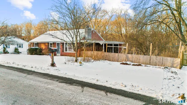 a view of a house with snow on the road