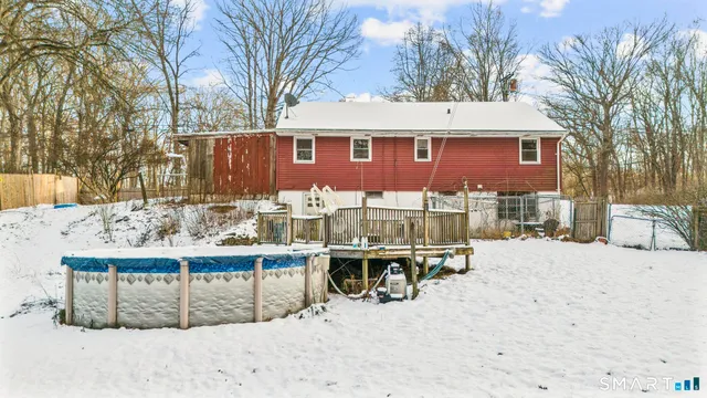 a view of a house with a yard covered in snow