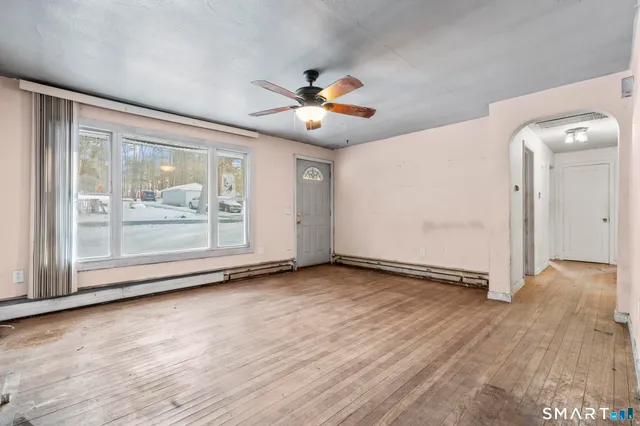 a spacious bathroom with a toilet sink and mirror