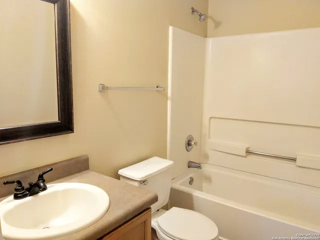 a bathroom with a toilet a sink and bathtub