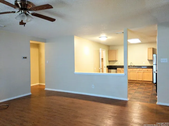 a living room with stainless steel appliances kitchen island granite countertop furniture and a large window