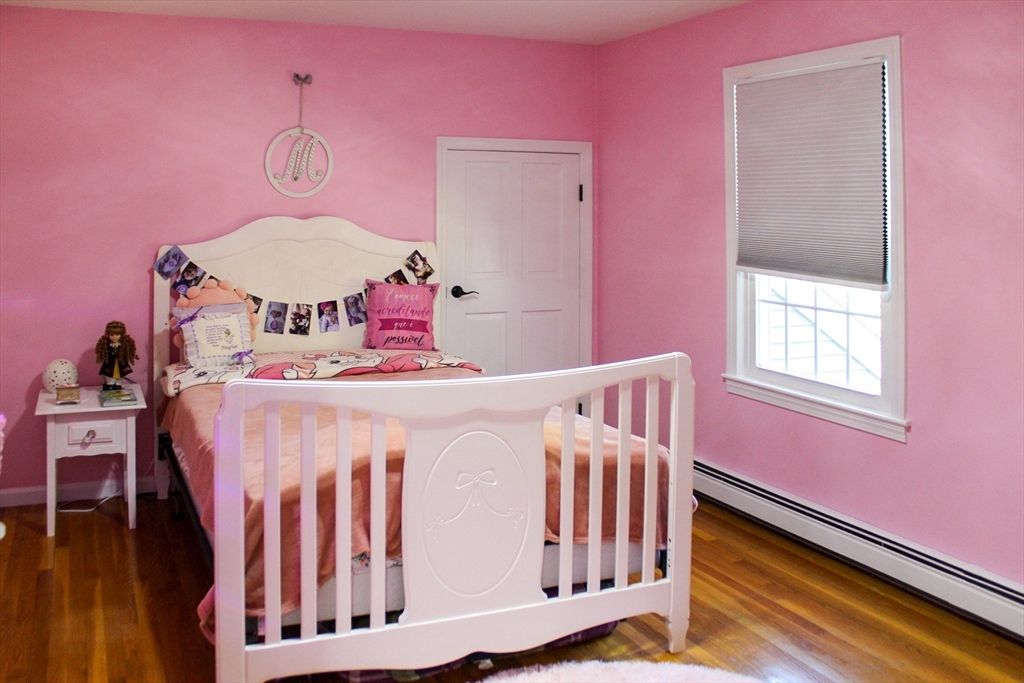 2 Applewood Circle Shrewsbury, MA 01545 - Photo 26 of 40 a bedroom with pink walls and wooden floor