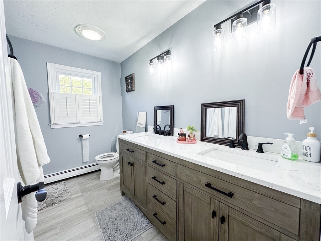 2 Applewood Circle Shrewsbury, MA 01545 - Photo 27 of 40 a bathroom with a granite countertop sink mirror vanity and a bathtub