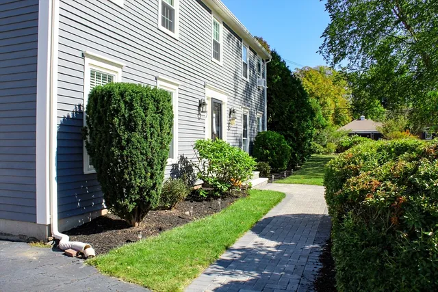 a view of a house with a yard and plants