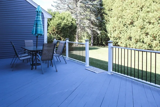 a view of a house with a small yard and wooden fence