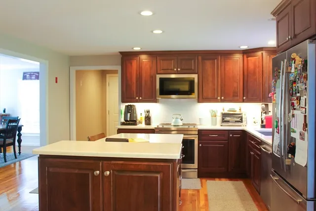 a kitchen with a sink a stove top oven a counter space and cabinets