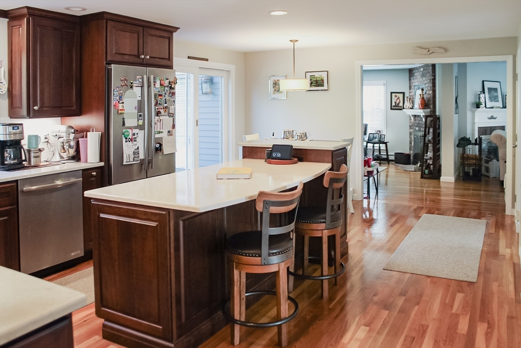 2 Applewood Circle Shrewsbury, MA 01545 - Photo 10 of 40 a kitchen with stainless steel appliances kitchen island granite countertop a table chairs and a refrigerator