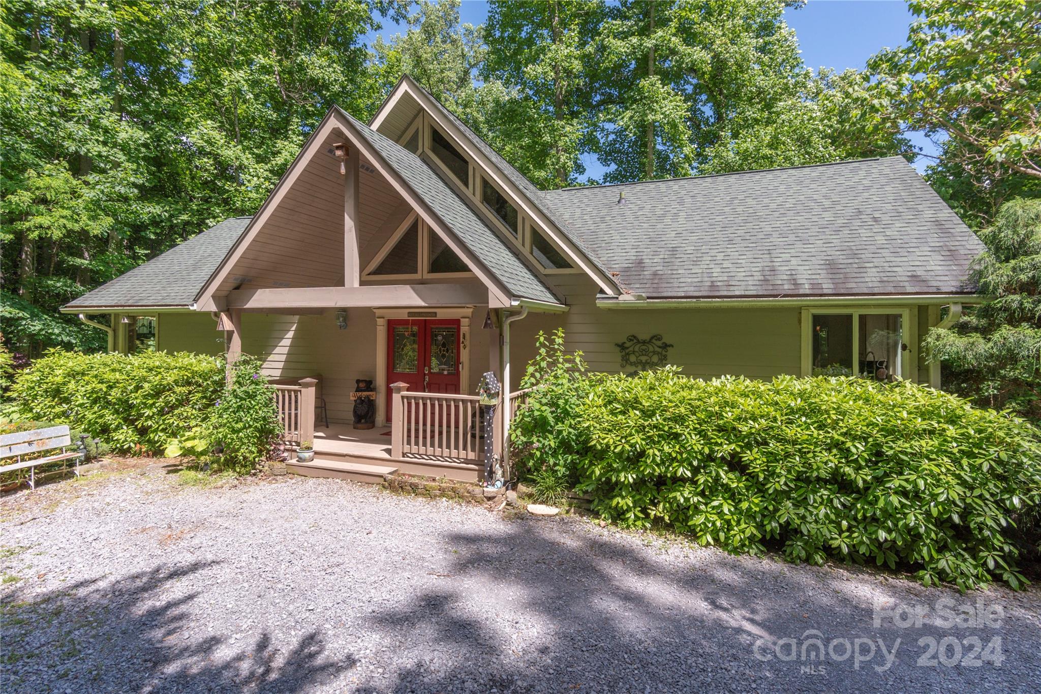 3191 Pigeon Road Waynesville, NC 28786 - Photo 1 of 33 a front view of a house with garden
