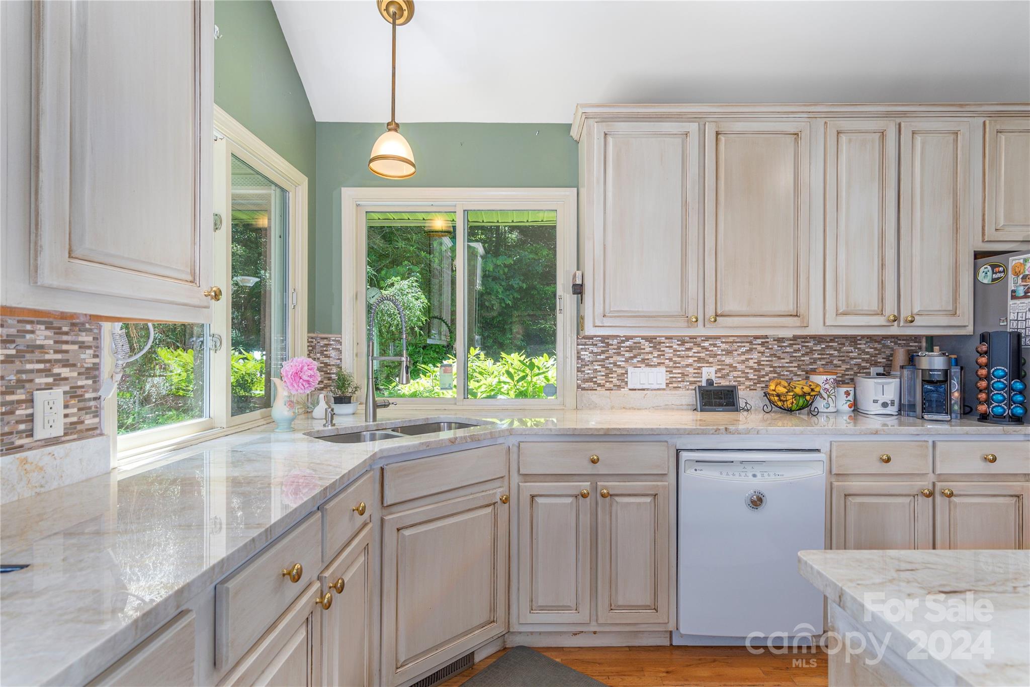3191 Pigeon Road Waynesville, NC 28786 - Photo 12 of 33 a kitchen with stainless steel appliances granite countertop a sink a stove and cabinets